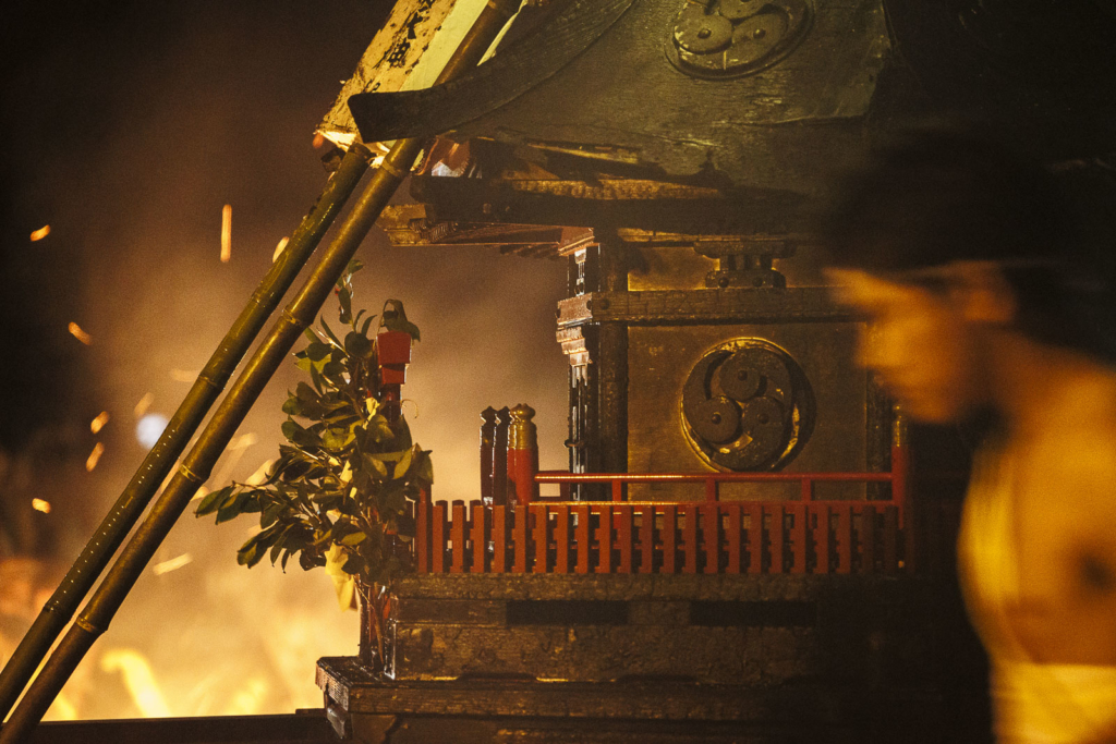 Mikoshi with flames on the background