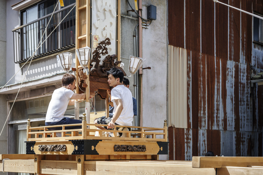 People working on Kiriko lantern float