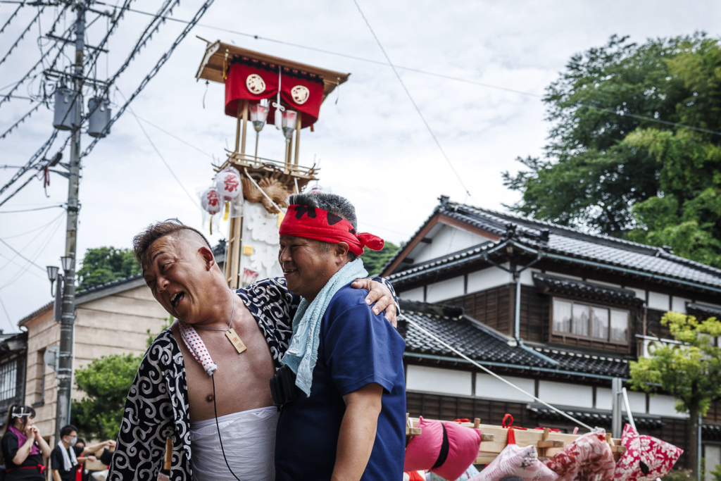 Two friends stand near Kiriko lantern float